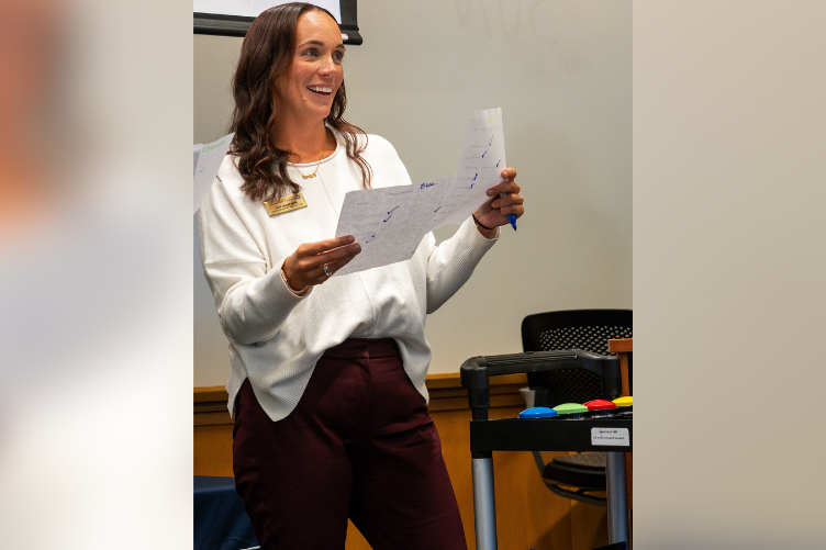 Annie Nevells, director of graduate enrollment and advising, welcomes grad students to a recent mixer event at Paul College..